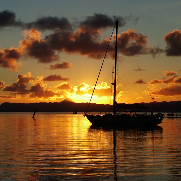 Sailboat anchored with sunset